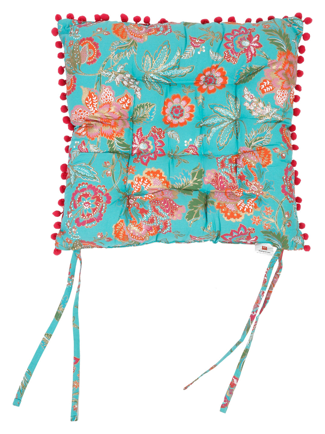 Comfy chair pad featuring a charming blue floral print accented with fluffy red pom poms, perfect for bringing a touch of cottagecore style indoors.
