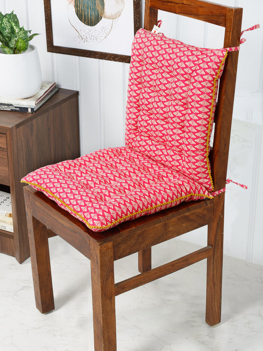 A soft pink chair pad with a delicate white wave print, adding a touch of springtime freshness to any chair.