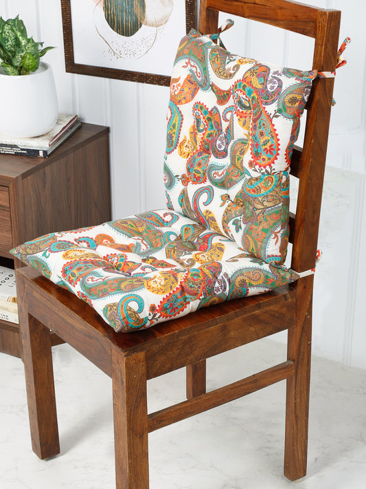 Eye-catching chair pad featuring a vibrant paisley print in a mix of pink, orange, green, and purple, adding a touch of bohemian flair to any chair.